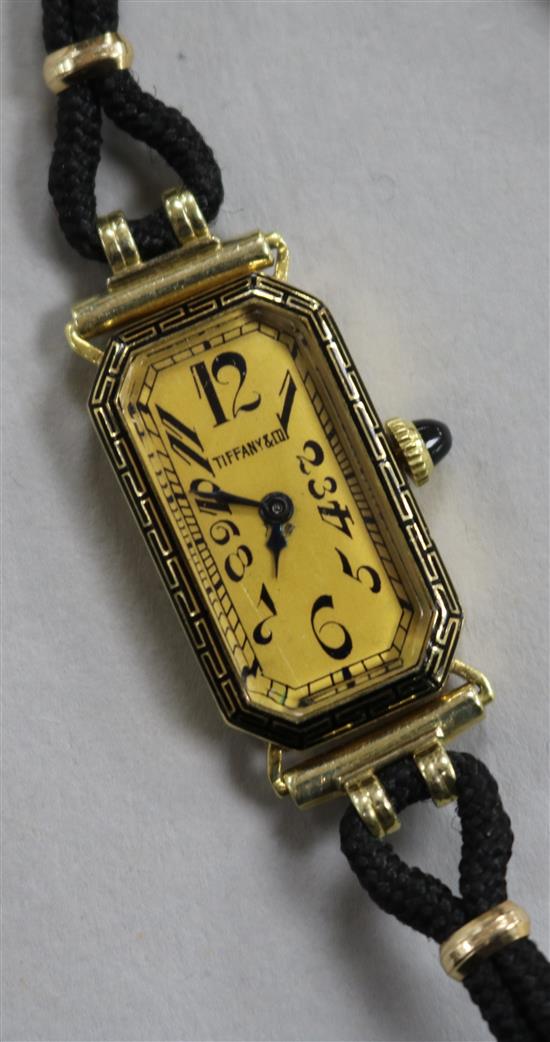 A ladys 18ct gold Longines manual wind wrist watch retailed by Tiffany & Co, on fabric strap.